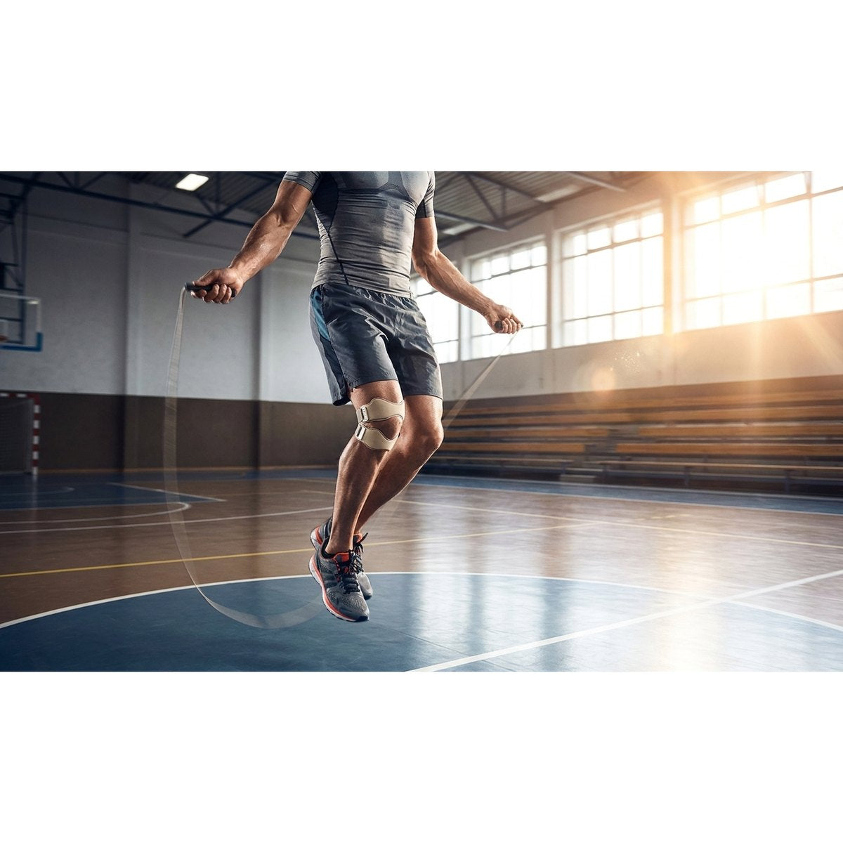 Deportista usando KneePro correa patelar rodilla corriendo entrenamiento funcional sin dolor